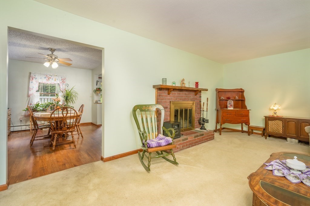 449 Springfield Street Palmer, MA 01069 - Photo 6 of 37 a living room with furniture a dining table and chairs