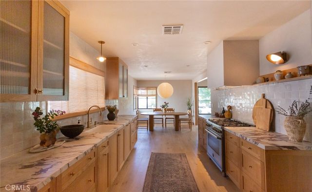a living room with furniture a window and a potted plant