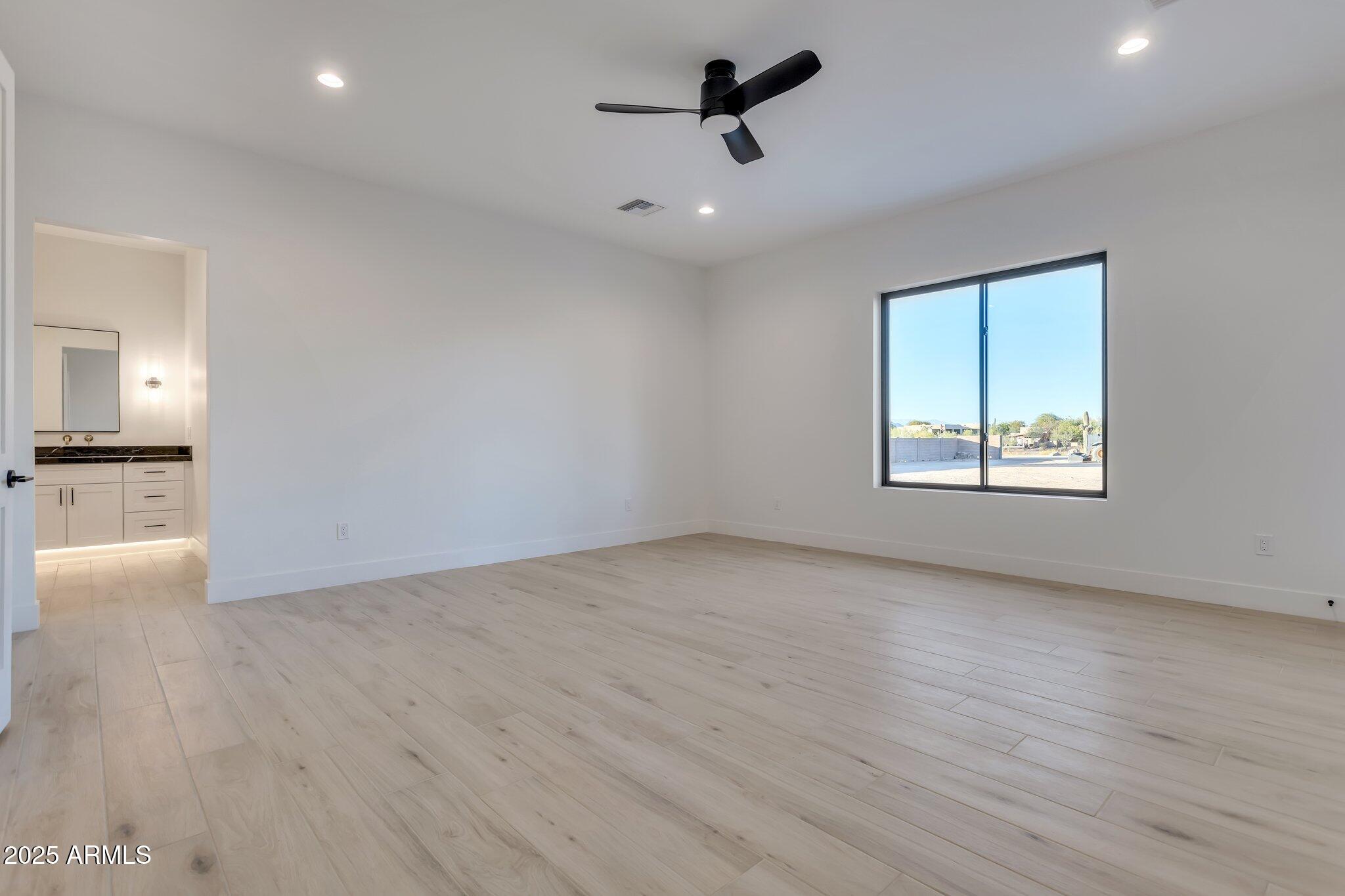 1602 East Cloud Road Phoenix, AZ 85086 - Photo 17 of 45 wooden floor in an empty room with a window