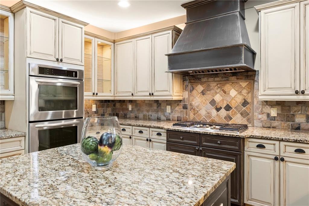 487 Carmichael Circle Canton, GA 30115 - Photo 13 of 65 a kitchen with stainless steel appliances granite countertop a stove a sink and a refrigerator