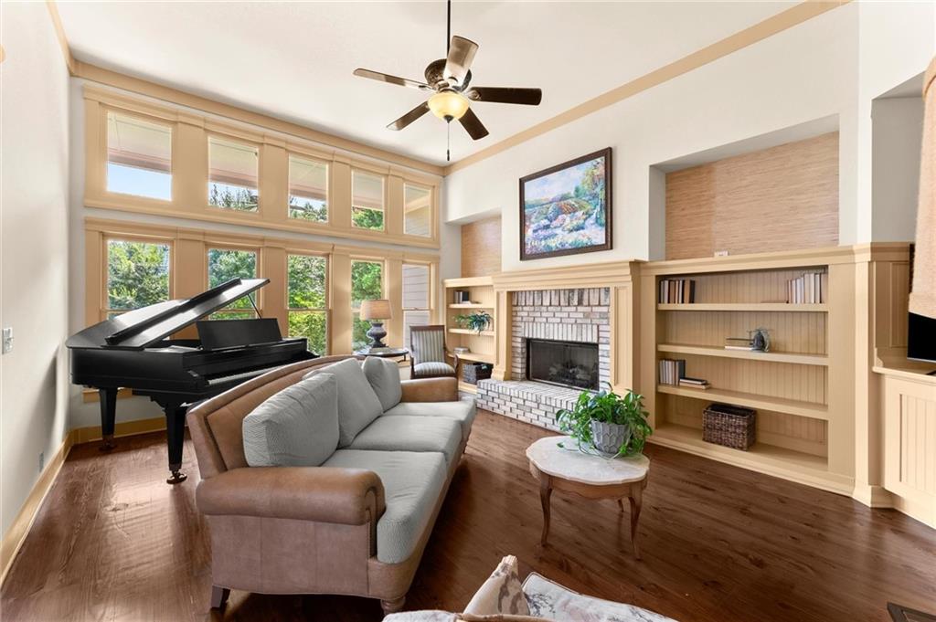487 Carmichael Circle Canton, GA 30115 - Photo 16 of 65 a living room with furniture a fireplace and a large window