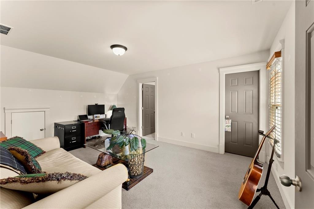487 Carmichael Circle Canton, GA 30115 - Photo 20 of 65 a living room with furniture gym equipment and a view of bedroom