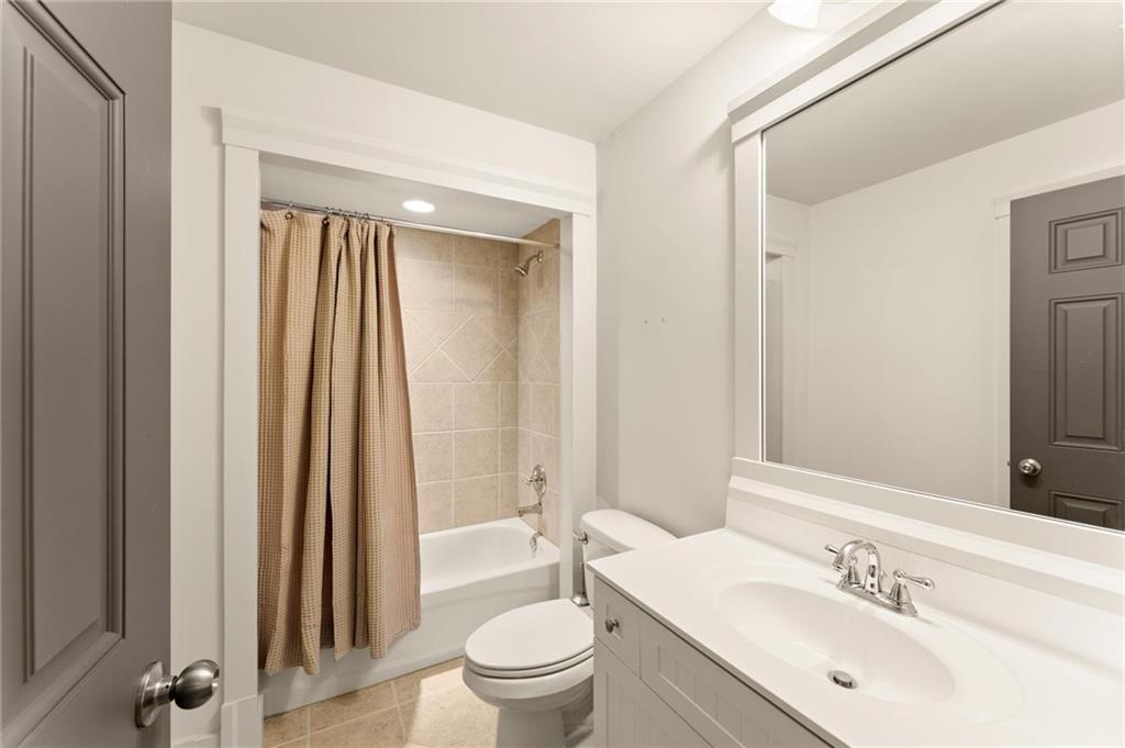 487 Carmichael Circle Canton, GA 30115 - Photo 22 of 65 a bathroom with a sink a toilet and a mirror