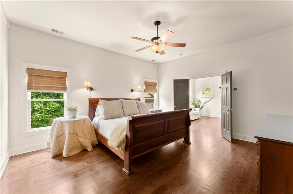 487 Carmichael Circle Canton, GA 30115 - Photo 28 of 65 a bed room with a bed and a chandelier