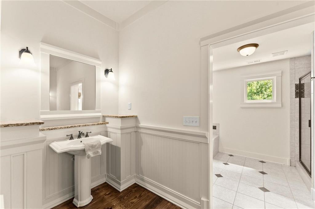 487 Carmichael Circle Canton, GA 30115 - Photo 30 of 65 a bathroom with a sink a mirror and a shower