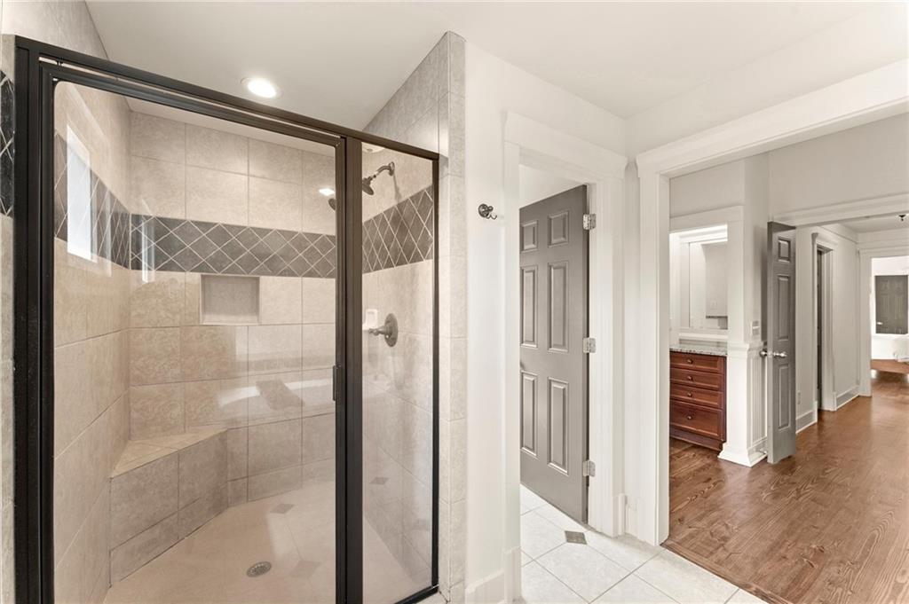 487 Carmichael Circle Canton, GA 30115 - Photo 33 of 65 a bathroom with a glass shower door and a mirror