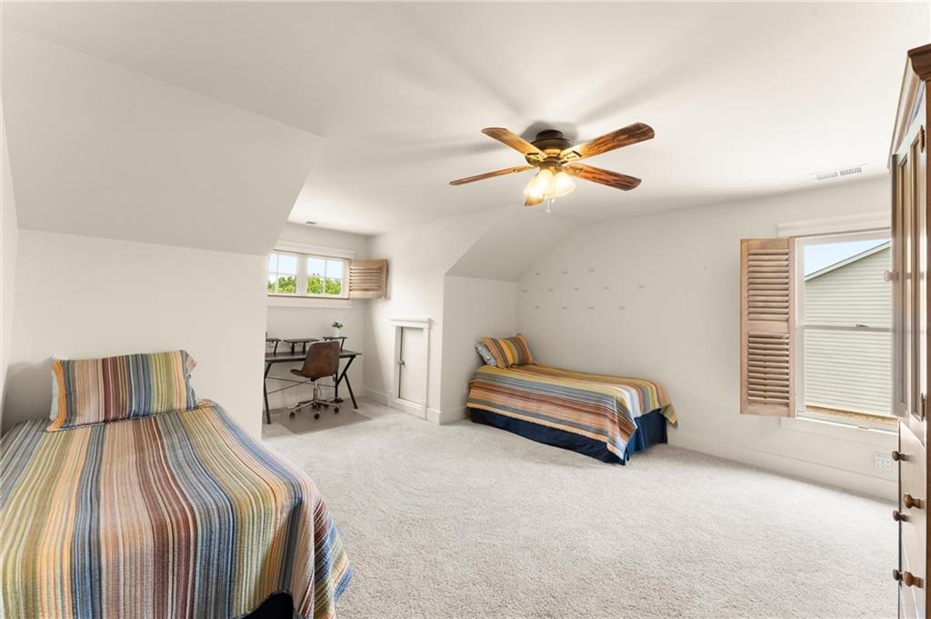 487 Carmichael Circle Canton, GA 30115 - Photo 36 of 65 a bedroom with a bed and a chandelier