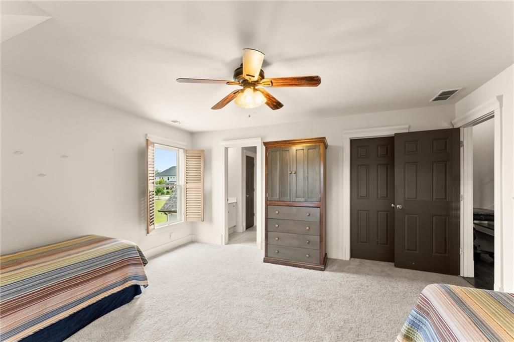 487 Carmichael Circle Canton, GA 30115 - Photo 38 of 65 a bedroom with a bed and a chandelier