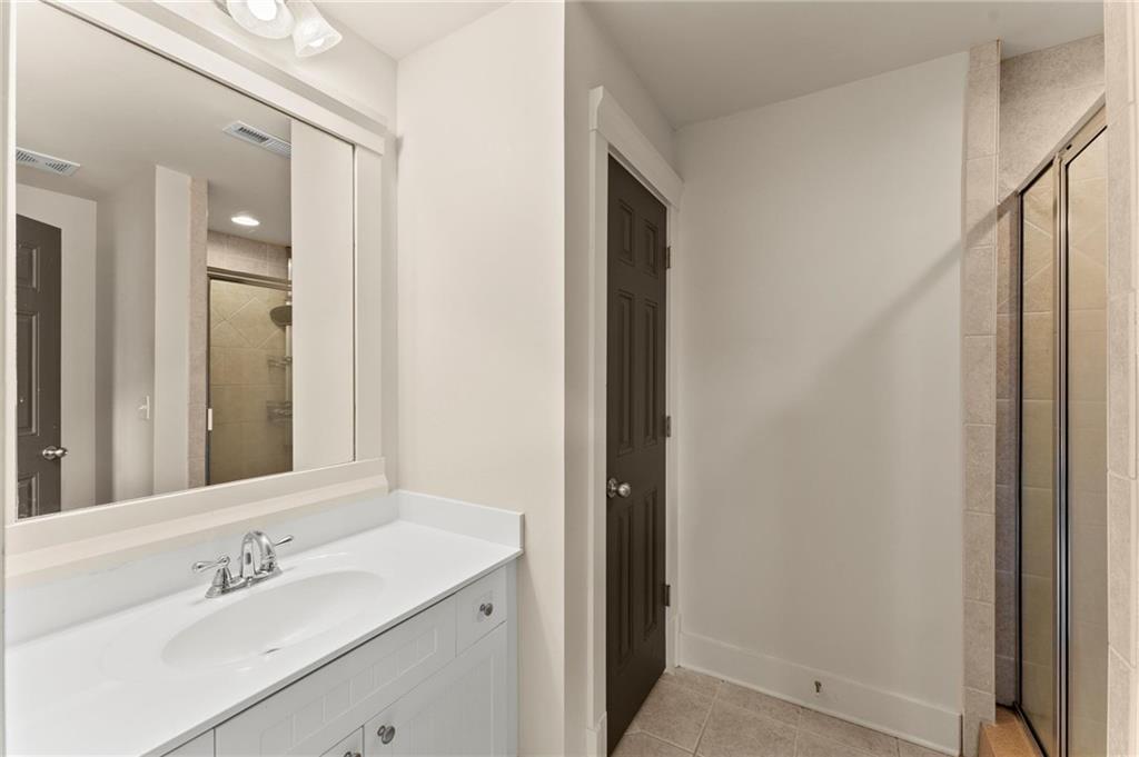 487 Carmichael Circle Canton, GA 30115 - Photo 39 of 65 a bathroom with a sink and a mirror