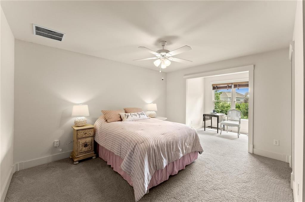 487 Carmichael Circle Canton, GA 30115 - Photo 43 of 65 a bedroom with a bed and a chandelier