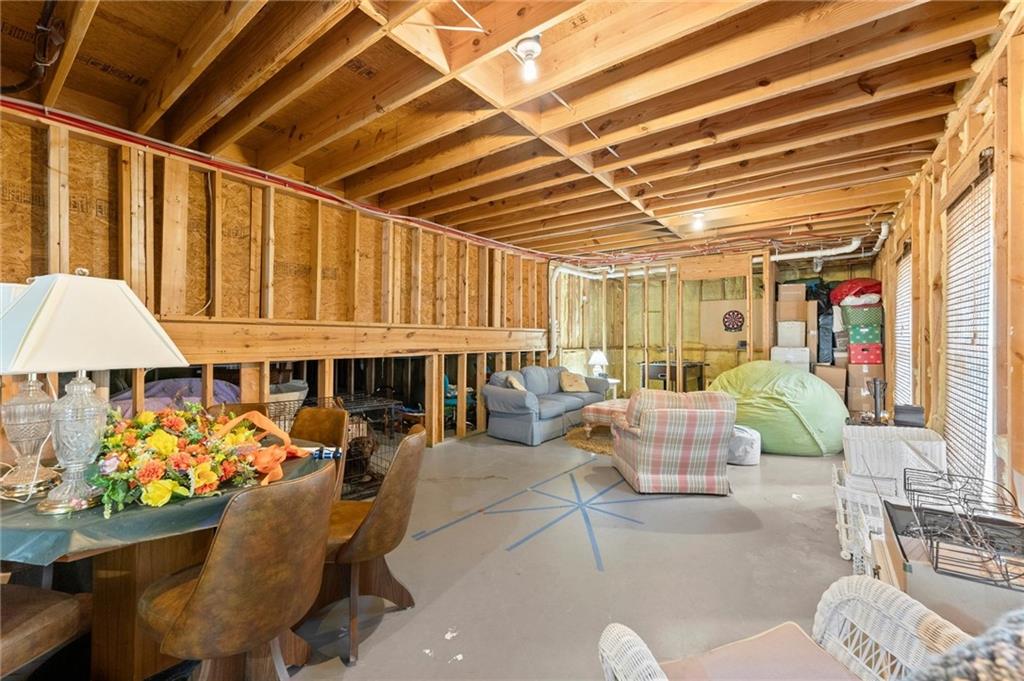 487 Carmichael Circle Canton, GA 30115 - Photo 47 of 65 a living room filled with furniture and a chandelier