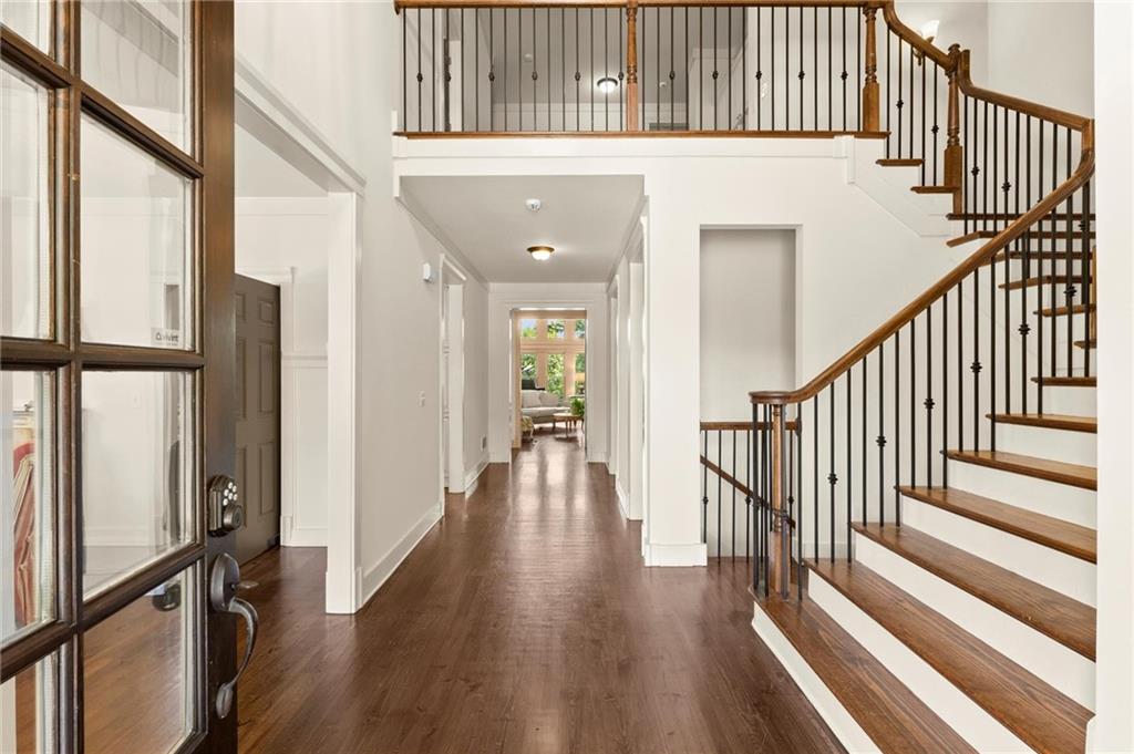 487 Carmichael Circle Canton, GA 30115 - Photo 5 of 65 a view of a hallway with wooden floor and staircase