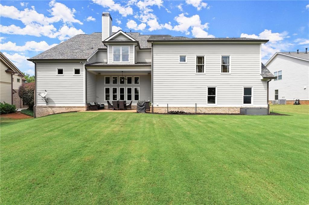 487 Carmichael Circle Canton, GA 30115 - Photo 52 of 65 a front view of a house with garden