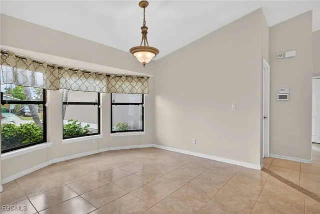 a view of an entrance with ceiling fan and window
