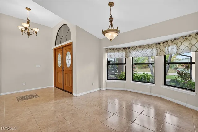 a kitchen with stainless steel appliances granite countertop a stove a sink a microwave a refrigerator and a microwave