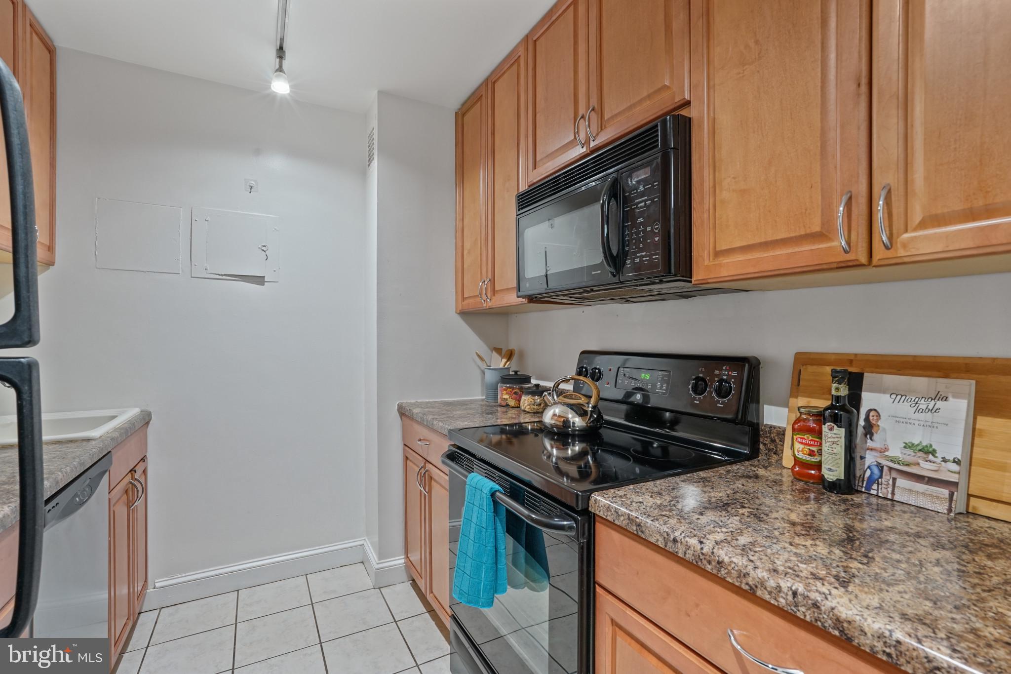 1435 4th Street Southwest, Unit B107 Washington, DC 20024 - Photo 8 of 42 a kitchen with a stove and a microwave