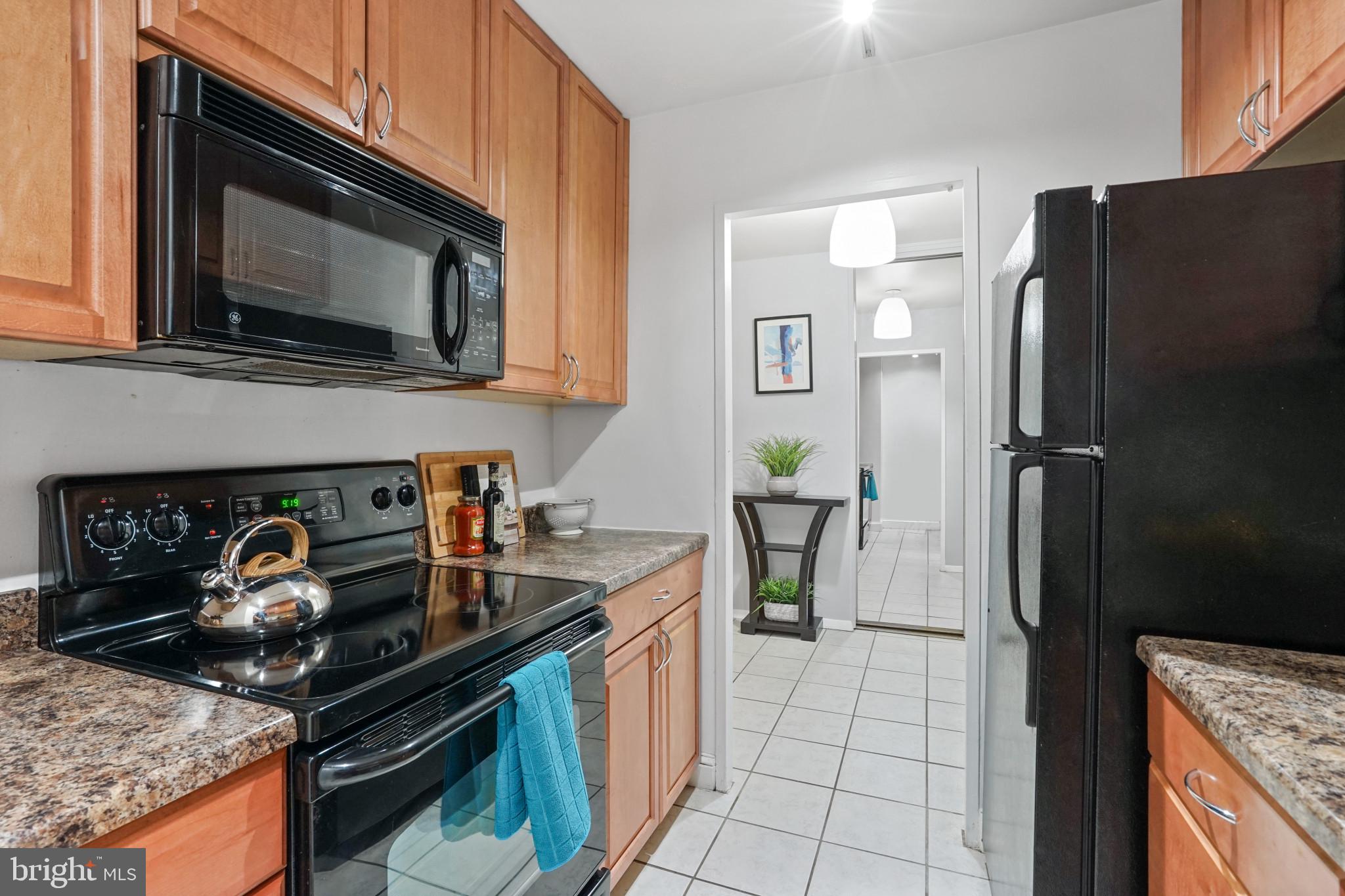1435 4th Street Southwest, Unit B107 Washington, DC 20024 - Photo 9 of 42 a kitchen with stainless steel appliances granite countertop a stove and a microwave