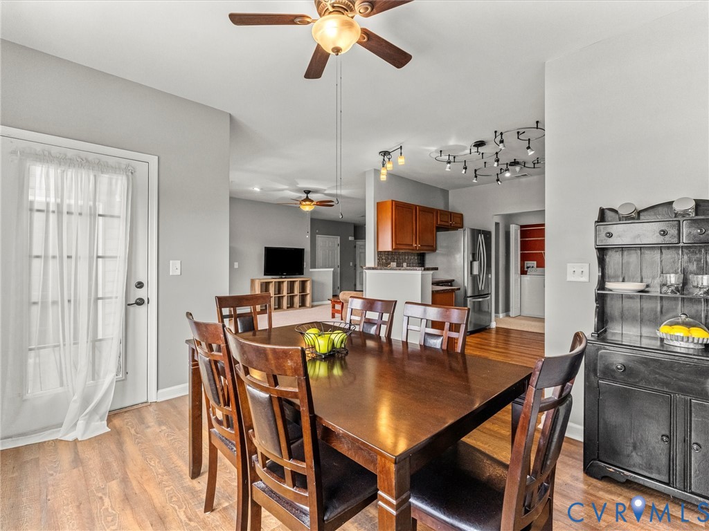 14000 Briars Circle, Unit 304 Midlothian, VA 23114 - Photo 15 of 27 a view of a dining room with furniture and wooden floor