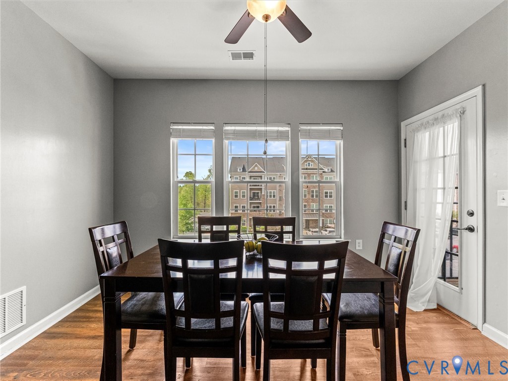 14000 Briars Circle, Unit 304 Midlothian, VA 23114 - Photo 16 of 27 a view of a dining room with furniture window and wooden floor