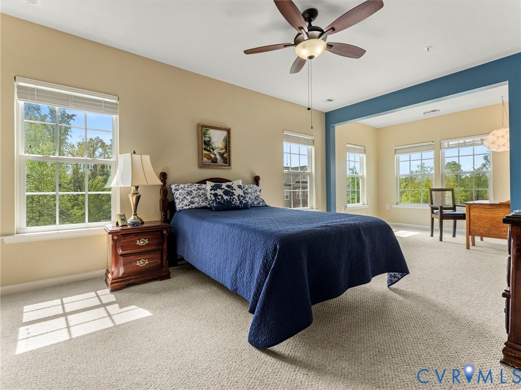 14000 Briars Circle, Unit 304 Midlothian, VA 23114 - Photo 17 of 27 a bedroom with a large bed and a chandelier fan