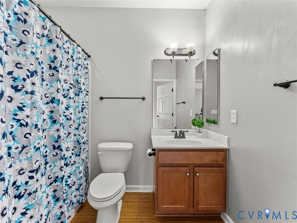 14000 Briars Circle, Unit 304 Midlothian, VA 23114 - Photo 27 of 27 a bathroom with a granite countertop toilet a sink and a mirror
