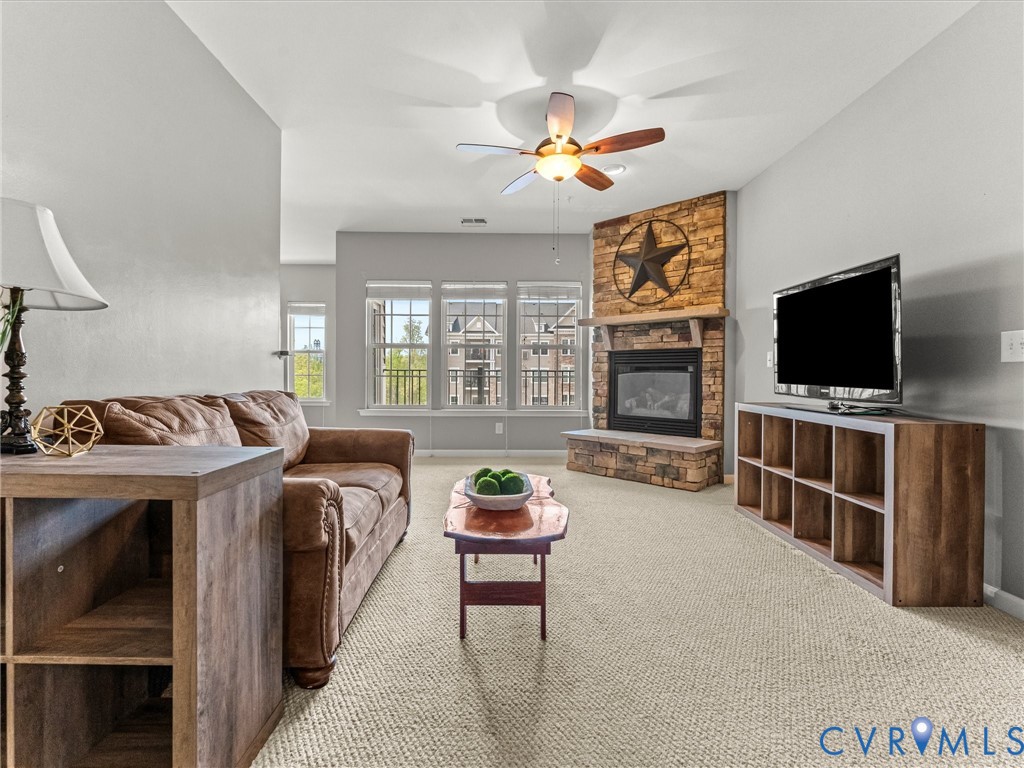 14000 Briars Circle, Unit 304 Midlothian, VA 23114 - Photo 6 of 27 a living room with furniture and a flat screen tv