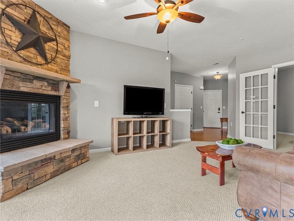 14000 Briars Circle, Unit 304 Midlothian, VA 23114 - Photo 8 of 27 a living room with furniture and a flat screen tv