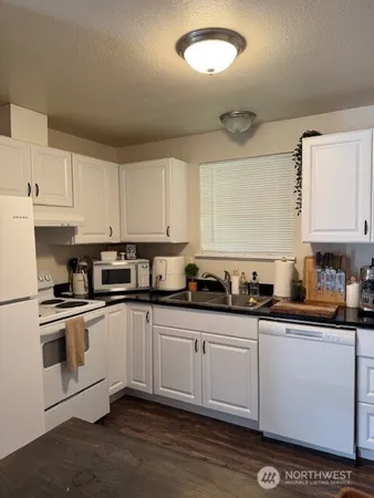 a kitchen with stainless steel appliances granite countertop a sink and cabinets