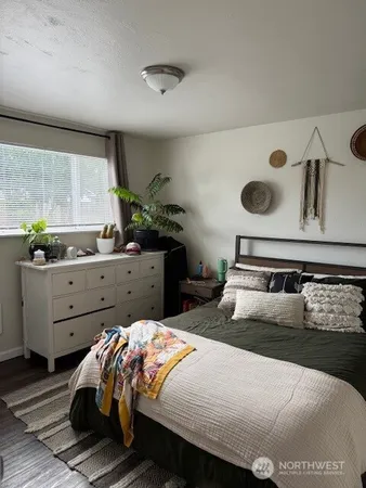 a bedroom with a bed and window