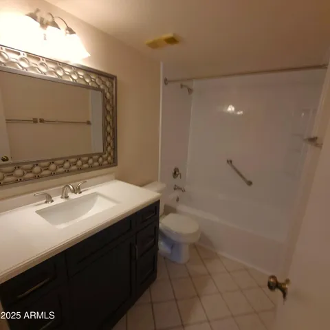 a bathroom with a sink toilet vanity and shower