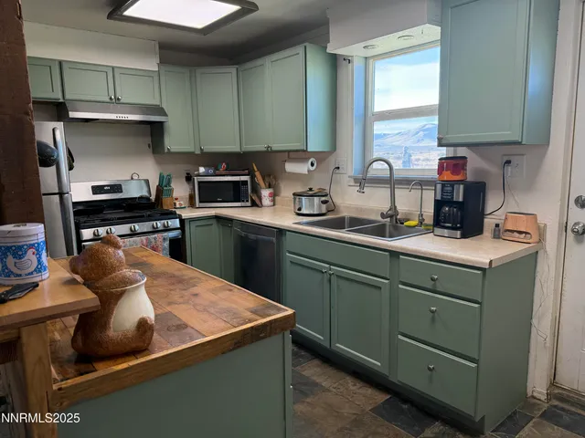 a kitchen with cabinets a sink and appliances