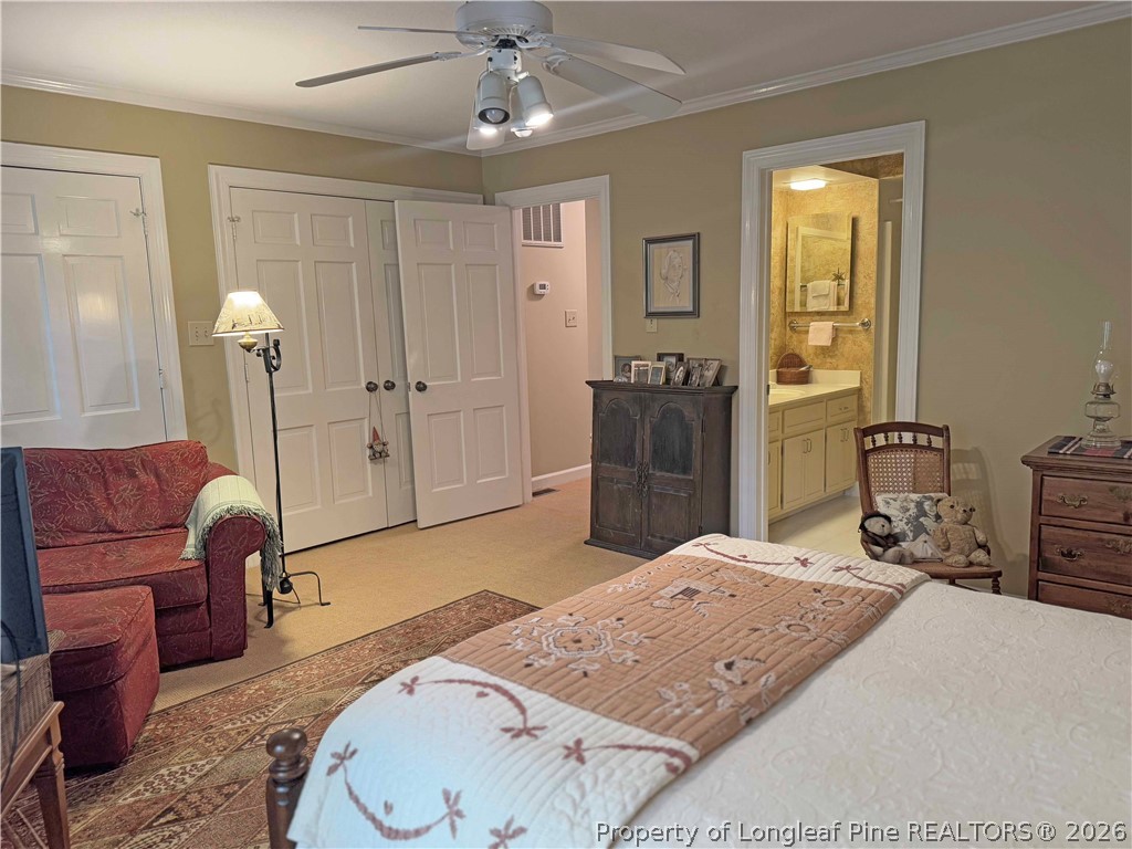 190 Palmetto Road Pinehurst, NC 28374 - Photo 13 of 19 a bedroom with a bed and dresser with mirror