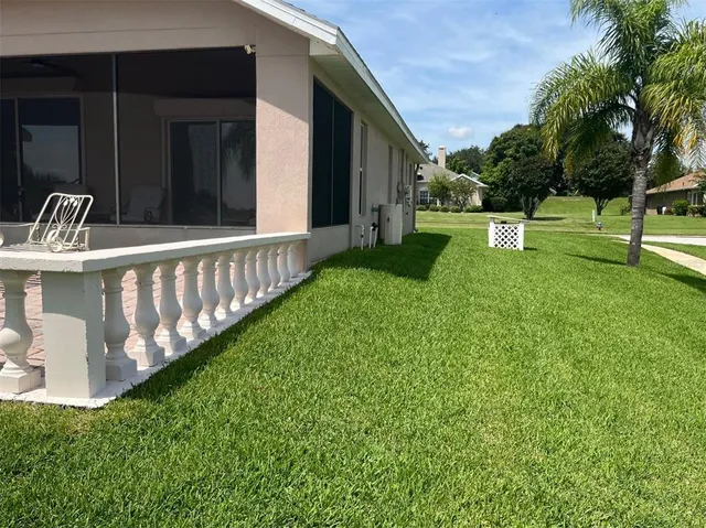 a view of a chair and table in the backyard