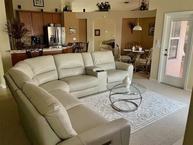 a living room with furniture a rug and a chandelier