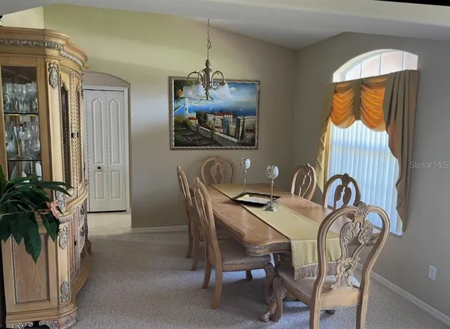 a dinning room with furniture and wooden floor