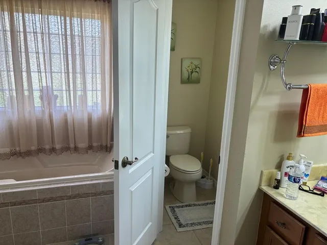 a bathroom with a sink a toilet and shower curtain