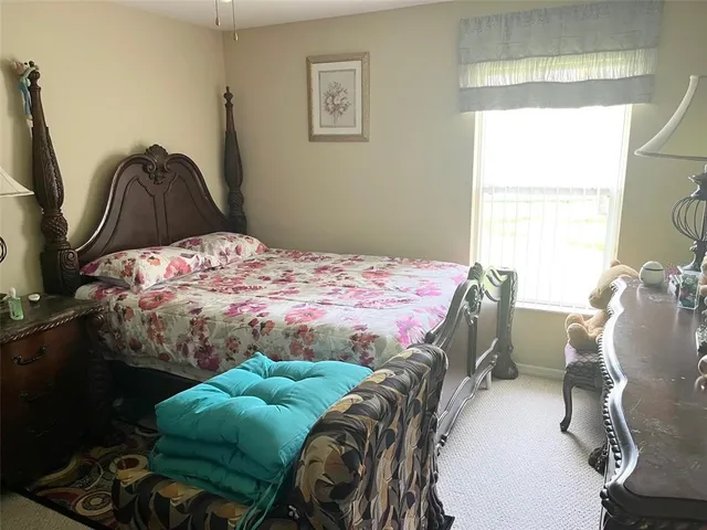 a bedroom with a bed and a chair