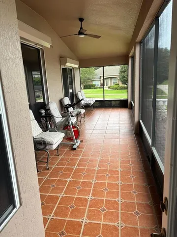 a living room with a large window and furniture