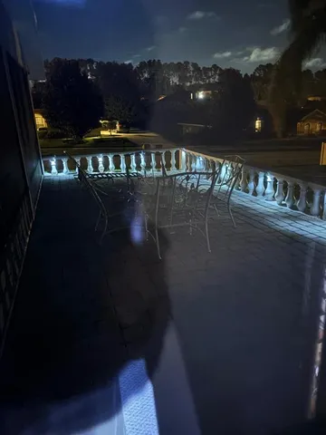 a view of back yard of the house and car parked