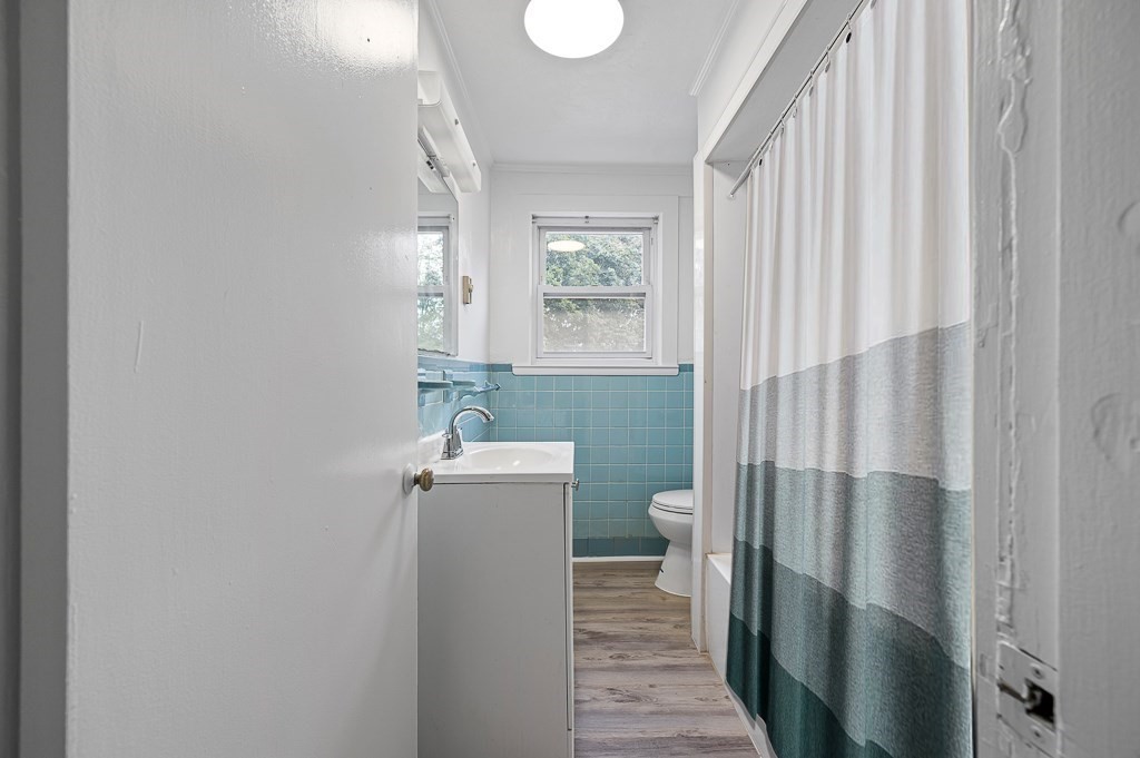 50 Ruggles Street, Unit 3 Franklin, MA 02038 - Photo 5 of 17 a bathroom with a toilet a sink and mirror