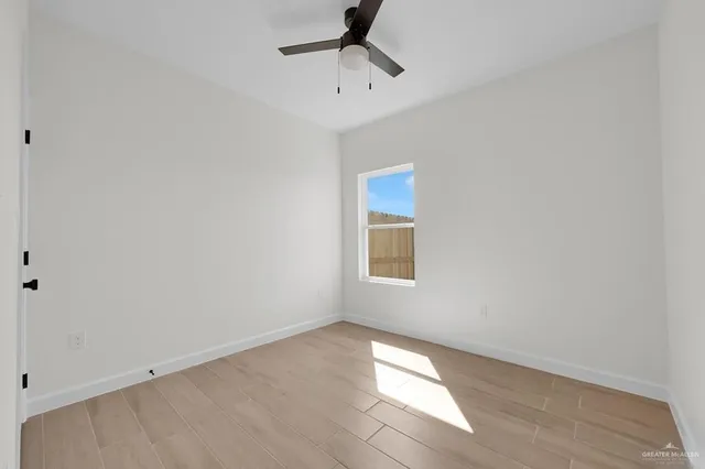 a view of a room with a window and a ceiling fan