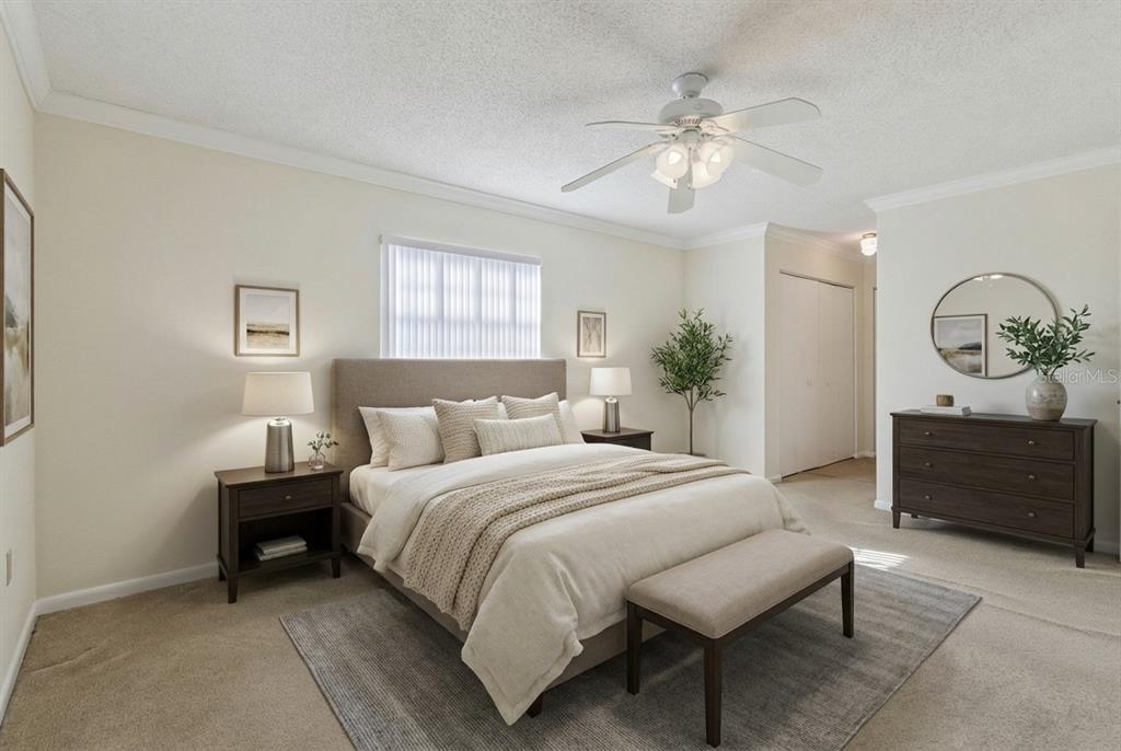 141 Northeast 50th Court Ocala, FL 34470 - Photo 19 of 42 a spacious bedroom with a bed and a chandelier