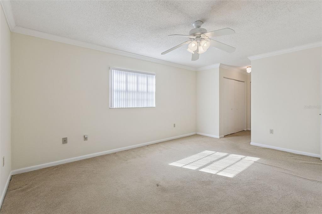 141 Northeast 50th Court Ocala, FL 34470 - Photo 20 of 42 an empty room with chandelier fan and windows