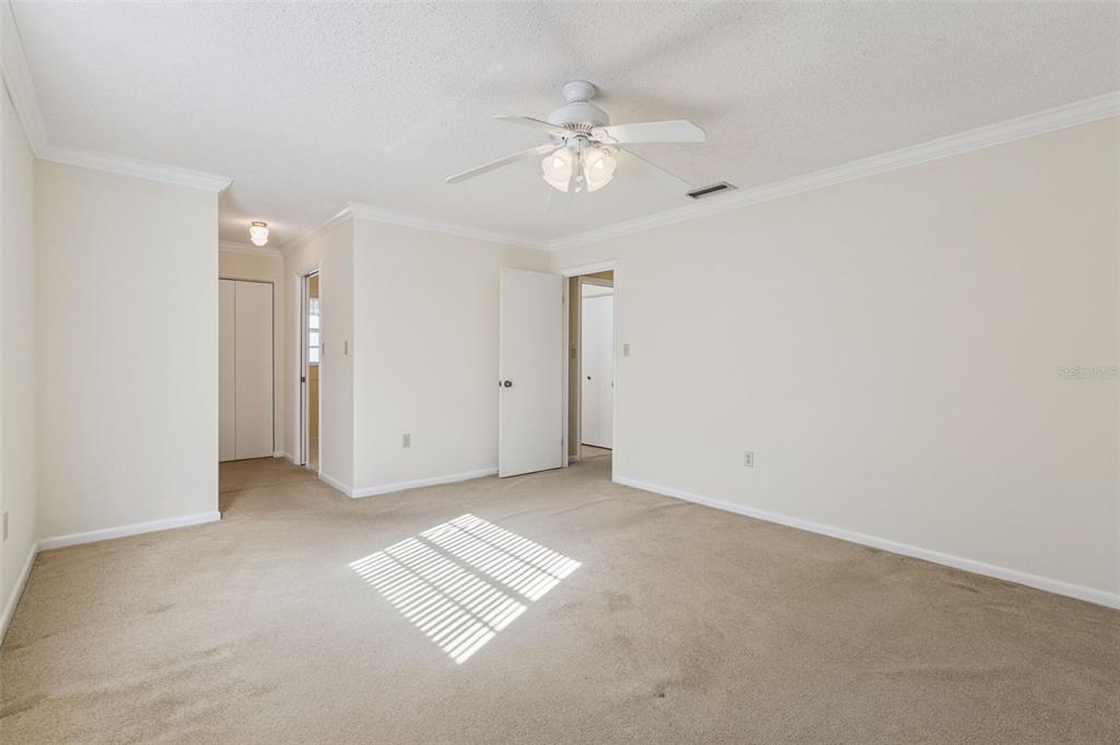141 Northeast 50th Court Ocala, FL 34470 - Photo 22 of 42 an empty room with a chandelier fan and windows