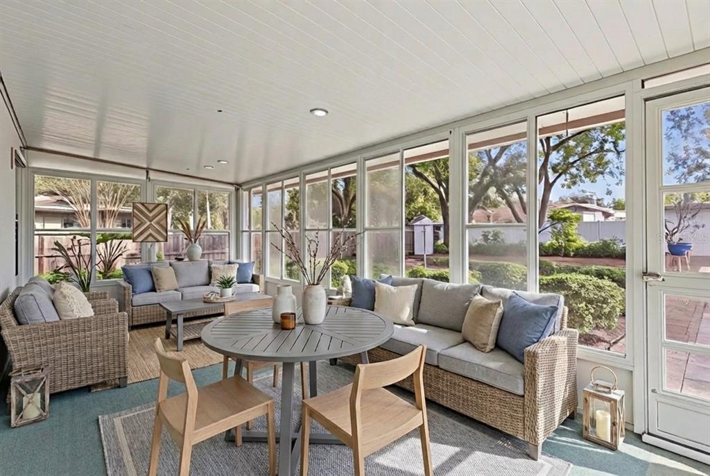 141 Northeast 50th Court Ocala, FL 34470 - Photo 27 of 42 a dining room with furniture a flat screen tv and a large window