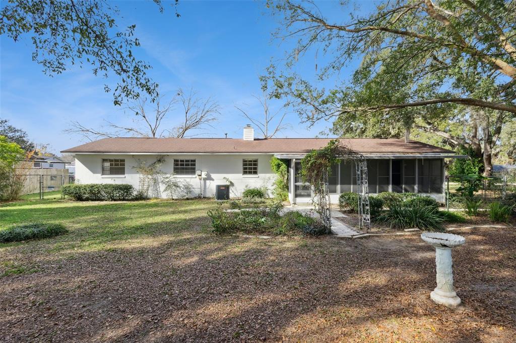 141 Northeast 50th Court Ocala, FL 34470 - Photo 34 of 42 a front view of a house with garden and porch