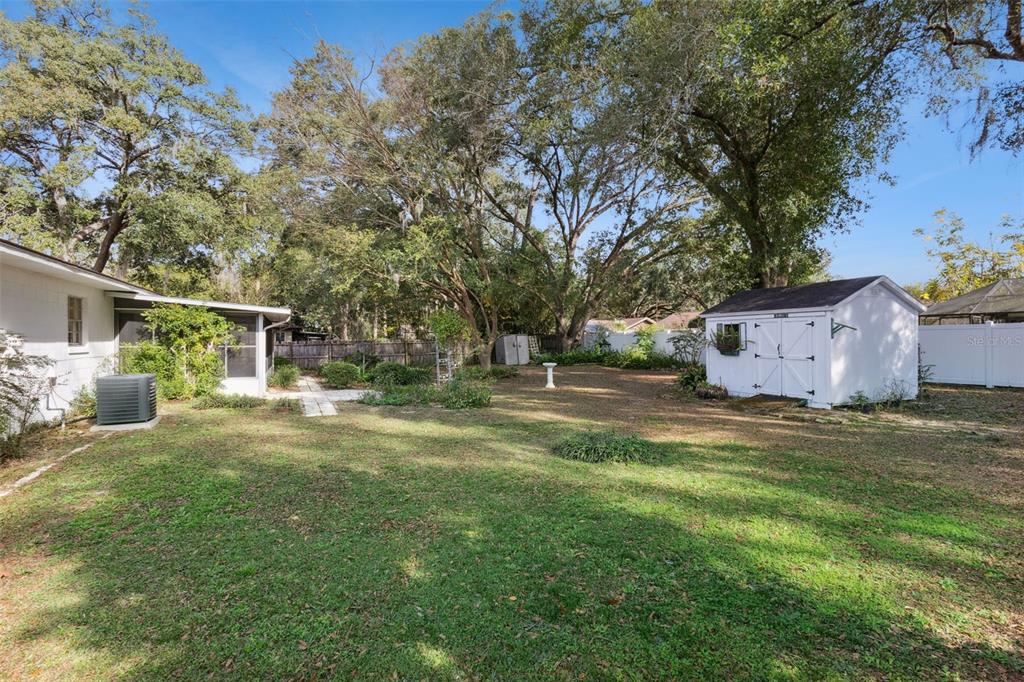 141 Northeast 50th Court Ocala, FL 34470 - Photo 36 of 42 a backyard of a house with table and chairs