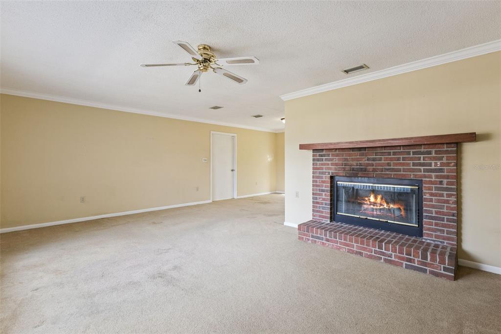 141 Northeast 50th Court Ocala, FL 34470 - Photo 5 of 42 a view of an empty room with a fireplace