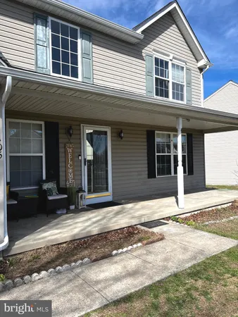 a kitchen with a sink refrigerator and wooden floor