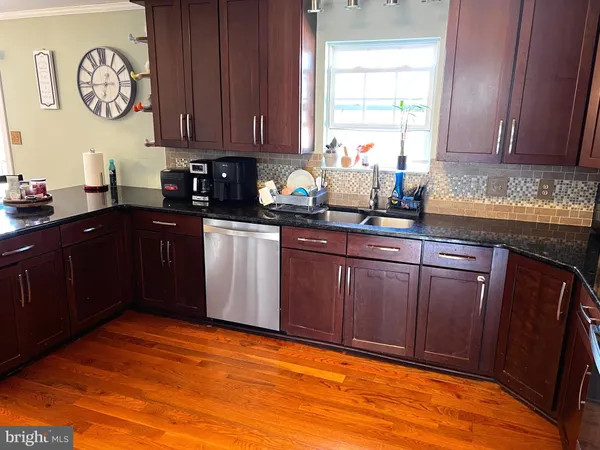 a bedroom with a bed wooden floor and window